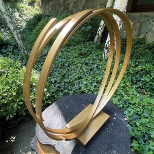 escultura dorada metálica circular